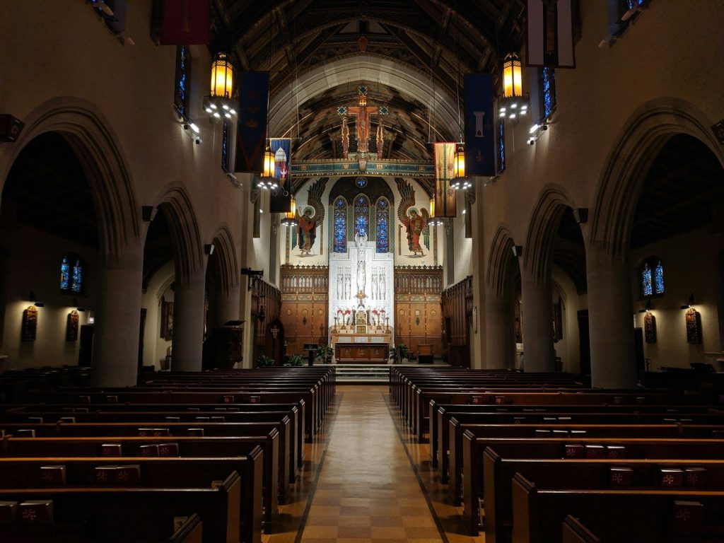 a church with pews and stained glass windows